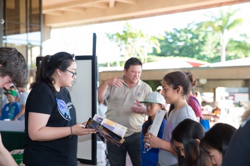 Public Information and Outreach Intern Alexis Acohido sharing the Gemini Career Brochure with students.