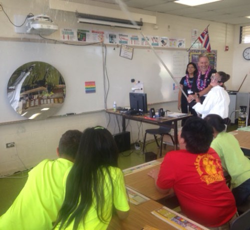 Gemini staff Peter Michaud and Alyssa Grace (black shirts, right to left) engaged students at Waiakea Elementary in an activity that simulates cleaning telescope mirrors.