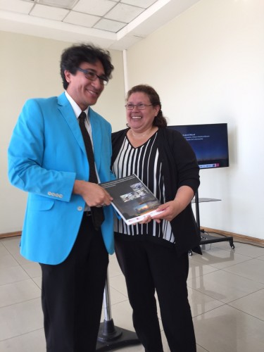 Maria Rebeca Lopez, teacher from La Serena School Carlos Condell de La Haza, presents the document to CONICYT representative Luis Chavarria, during the release ceremony at the Chilean Foreign Ministry.