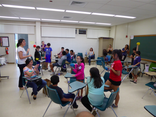 Gemini Astronomer Andreea Petric (left), leading an activity that models cosmic distances and time travel using Play-Doh.